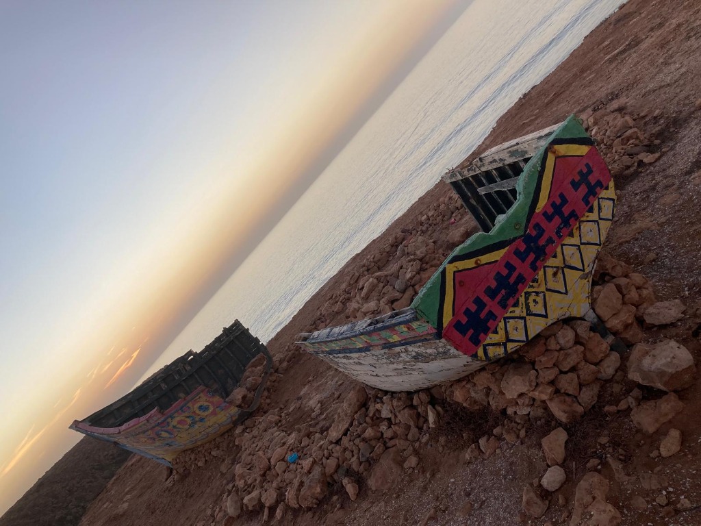 Colorful Berber fishing boats at Mirleft during sunset