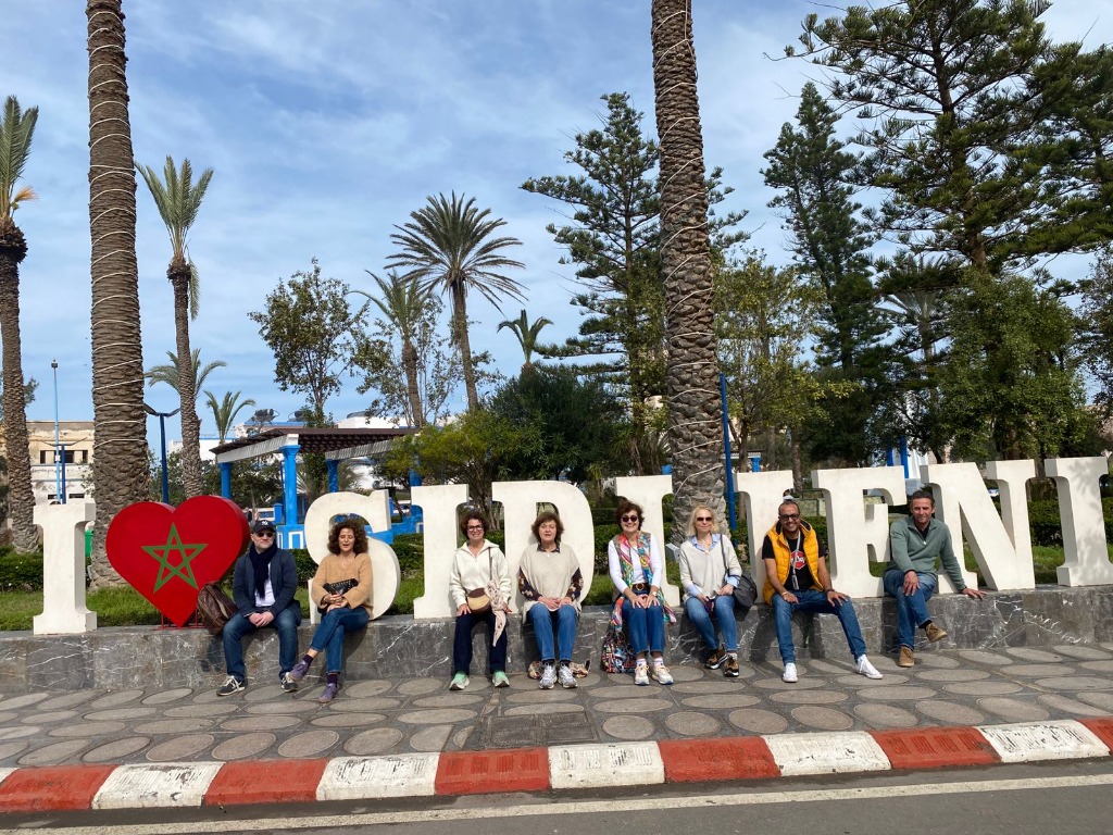 Group excursion taking a photo at the Sidi Ifni sign