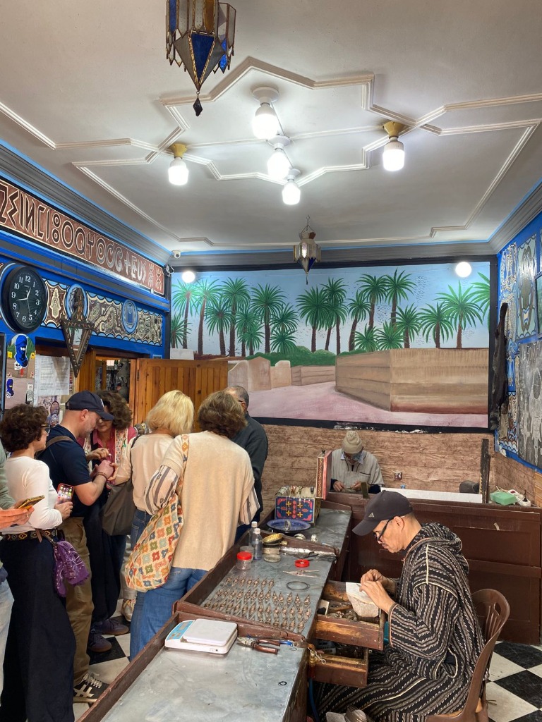 Group tour visiting a traditional silver jewelry shop in Tiznit