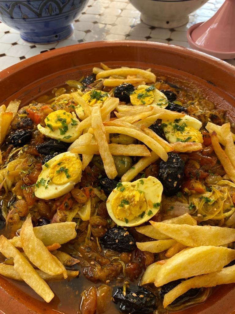 Sweet chicken tajine with prunes and fries in Aglou